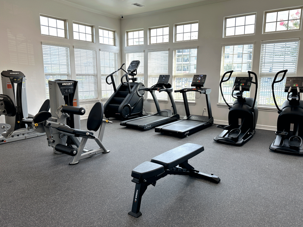 Multifamily housing fitness room featuring TRUE and HOIST equipment.