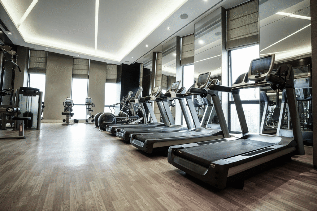 Corporate fitness center with treadmills and cardio equipment in a modern workplace gym.