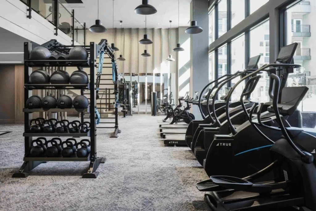 Modern fitness room featuring TRUE cardio and functional training equipment. cardio machine maintenance.