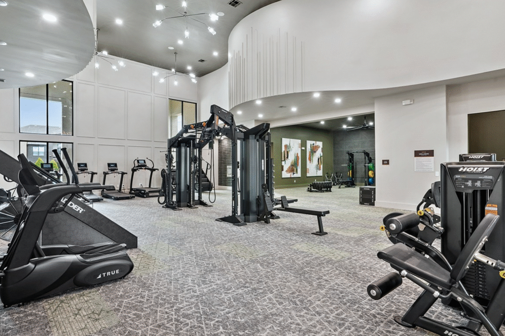 Multifamily housing fitness center with TRUE cardio and Hoist strength equipment in a modern apartment gym.